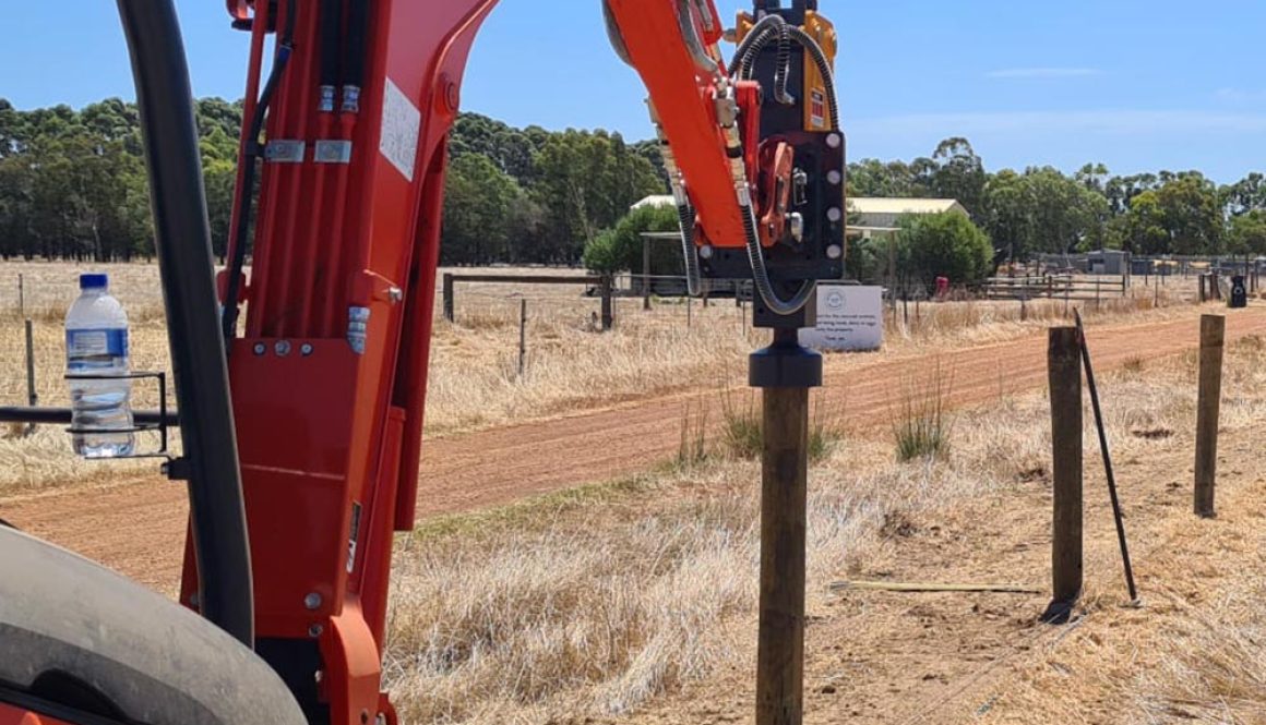 a red equipment Thor Post Driver making a hole